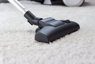 professional house cleaner using vacuum
